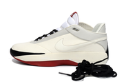 Side profile of an off-white Jordan 40 sneaker with black and red outsole accents.