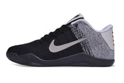 Black and white low-cut Kobe 11-style basketball shoe, side view