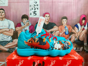 Side profile of a blue Nike sneaker with red laces, multicolor graphic detailing, a red swoosh, and a ribbed outsole.