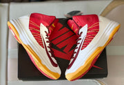Top view of a pair of red and white high-top basketball shoes with burgundy laces and gum-colored soles.
