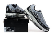 Nike Air Max 97 OG sneakers displayed with a shoe box showing a size label