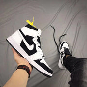 Angled side view highlighting the black and white upper, Swoosh-shaped side detail, and high-top profile.
