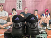 Rear view of the black and gray Adidas sneakers showing the heel branding and layered rear panels.