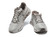 Front and top view of a pair of gray On Cloudmonster 3 shoes