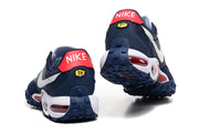 Rear view of the Nike Air Max Waffle SP sneakers, showing red heel panels and navy tread.