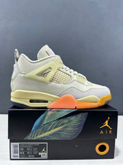 Side view of a light-colored Jordan Air Jordan 4 sneaker on its illustrated box; the box label shows EU 42, style code HV0823 101, and US sizes.