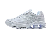 Side view of a white Nike Shox Ride 2 sneaker showing mesh panels and the sculpted sole.