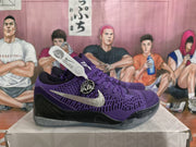 Side profile of a purple Nike basketball sneaker with a silver swoosh and circular side emblem.