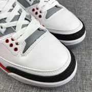 Close-up of the perforated gray lace panel, white toe box, and black textured toe overlay.