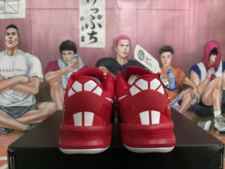 Rear view of red Nike sneakers with white heel accents on a black shoebox.