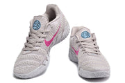 Front and angled views showing the gray lace-up shoes, textured uppers, and pink side accents