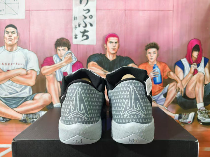 Rear view of black Nike basketball shoes with patterned gray heel panels and light-colored outsoles.