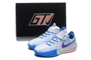 White and blue sneakers displayed in front of a black box marked with a GTJ logo.