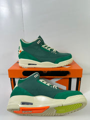 Detailed view of the sneaker outsole showing orange and lime sections, tread pattern, and heel Air unit.