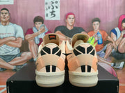 Rear view showing black-and-cream heel graphics on the pale pink Nike Kobe 8 Protro shoes