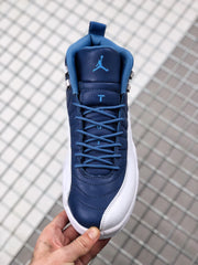 Top view of the indigo Jordan sneaker showing blue laces, padded tongue, and blue Jumpman branding.