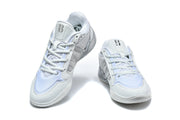 Pair of white and silver Nike LeBron basketball shoes shown from above