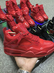 Close side view of a glossy red high-top sneaker showing mesh panels, side wings, and the midsole air window.