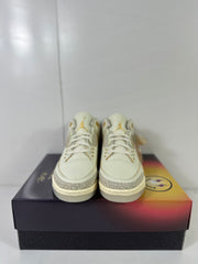 Front view of cream Jordan Air Jordan 3 Retro SP sneakers displayed on a gradient shoebox.