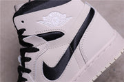 Close-up of the Jordan Wings logo, black Swoosh, and contrast panel.