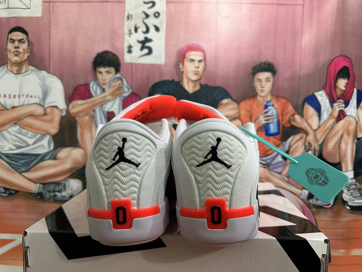 Rear view of white basketball shoes with black heel logos and red accents