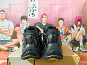 Rear view of black sneakers showing the heel panels and dark outsole.