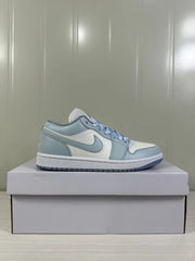 Clean side profile of one light blue-grey and white low-top sneaker.