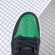 Close-up of the green perforated toe box and black surrounding overlay.