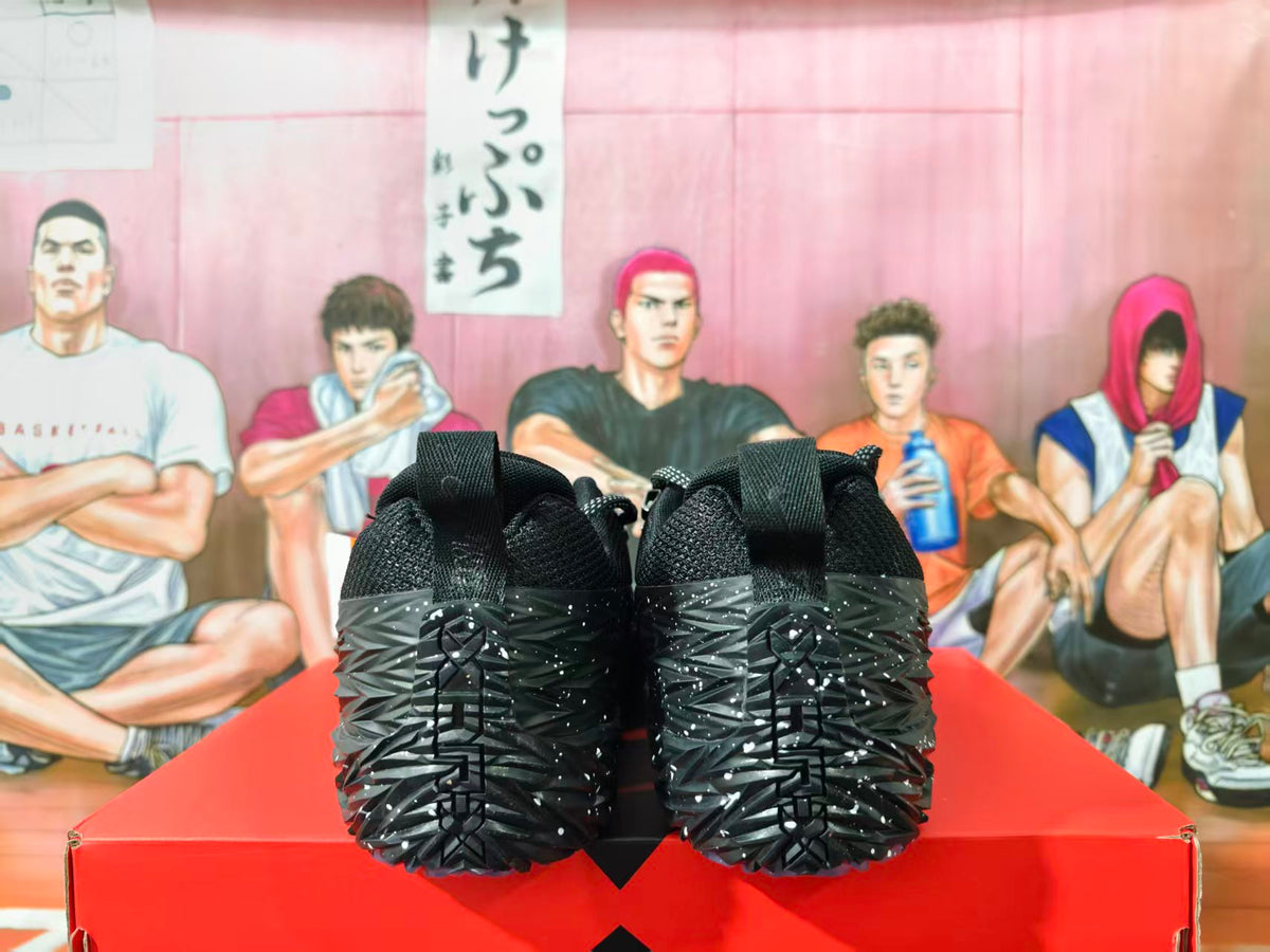 Rear view of black textured sneakers showing heel pull tabs and patterned soles.