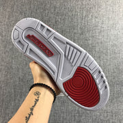 Underside view of the sneaker showing the red and white outsole.