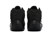 Rear view of the black Nike sneakers showing the layered heel detailing and textured soles.