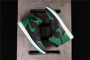 Top-down view of the pair showing contrasting black and green panels, white midsoles, and green outsoles.