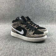 Three-quarter front view of the pair with leopard-print overlays, black toe boxes, white Swooshes, and white outsoles.
