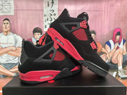 Pair of black and red Jordan 4-style sneakers shown from the side, highlighting the contrasting midsoles.