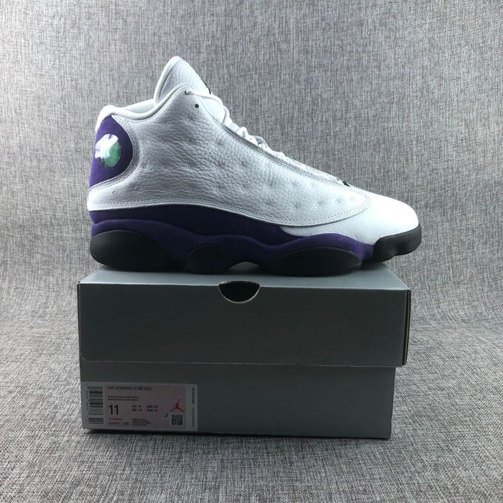 White and purple Air Jordan 13 sneaker displayed on its box