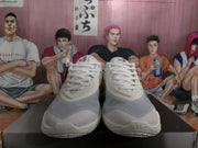 Front view of the pair showing white laces, grey translucent-looking toe panels and Air branding on the forefoot outsole.