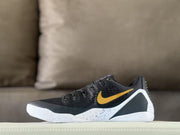 Opposite side view showing the black upper, gold Swoosh, white midsole, and speckled panel.