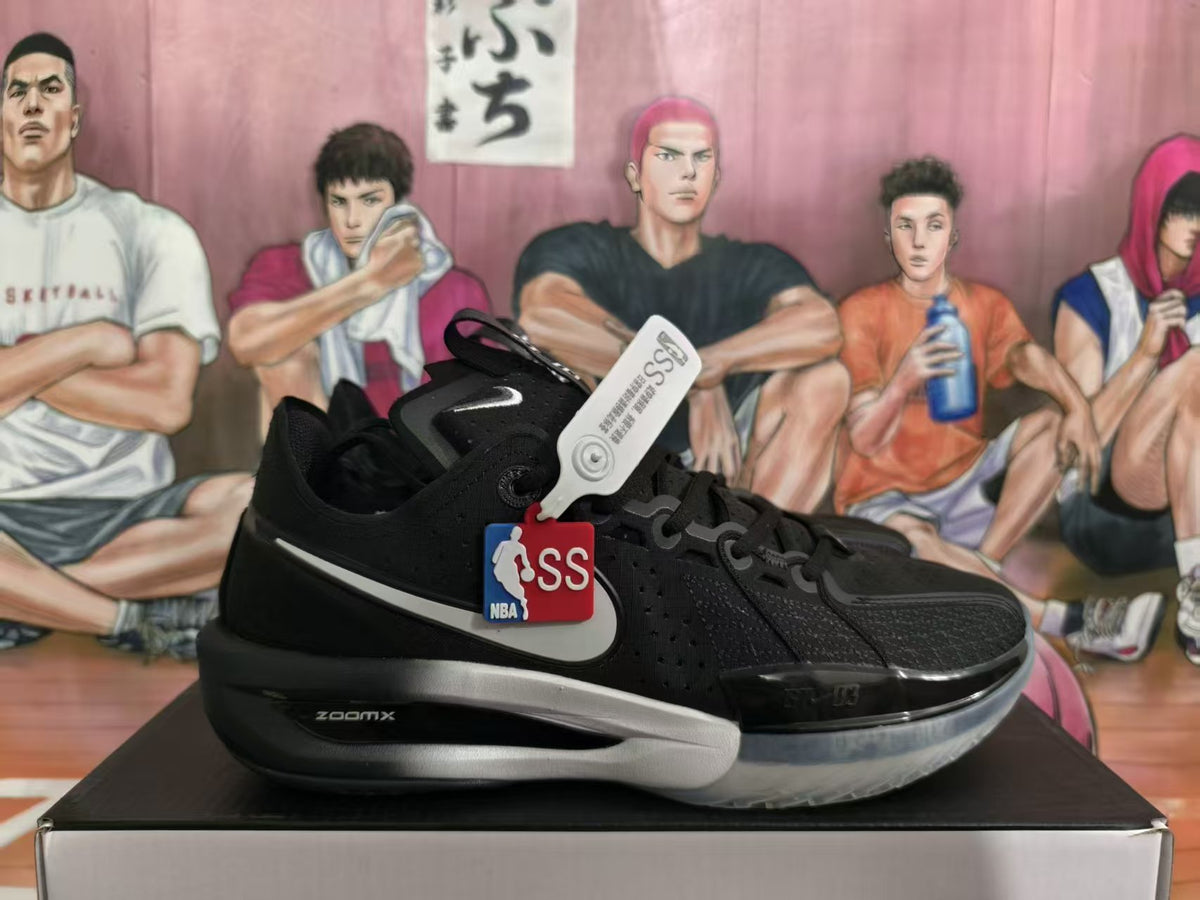 Black Nike basketball shoe with silver Swoosh, translucent outsole, and visible ZoomX lettering.