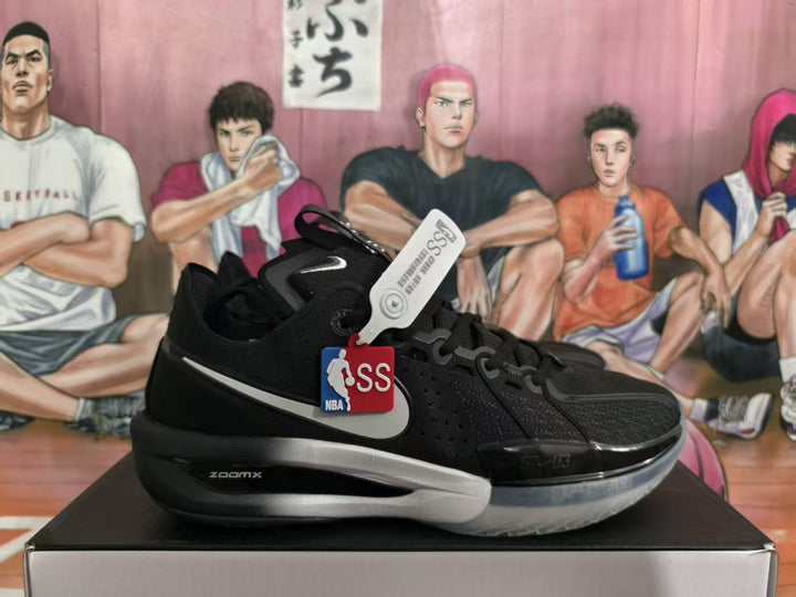 Black Nike basketball shoe with silver Swoosh, translucent outsole, and visible ZoomX lettering.