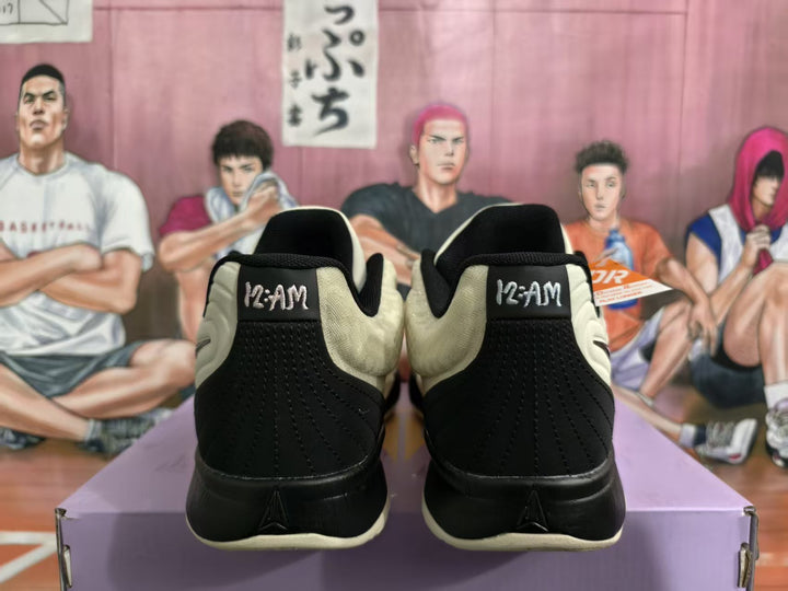 Rear view of beige and black basketball sneakers showing padded collars and heel branding
