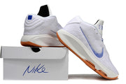 White and blue Nike GT Hustle 3 shoes posed on and beside a white shoe box.