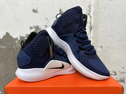 Pair of navy Nike basketball shoes shown at an angle on an orange box