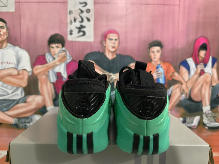Rear view of green sneakers with black padded collars, heel pull loops, and dark heel detailing.
