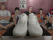 Front view of white Nike basketball sneakers with black Swoosh details displayed on a shoebox.