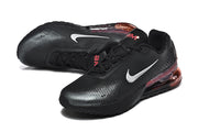 Angled view of black Nike Air Max 720 sneakers with white Swoosh logos and red accents.