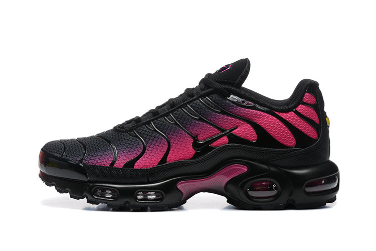Side view of black and pink Nike Air Max Plus sneakers
