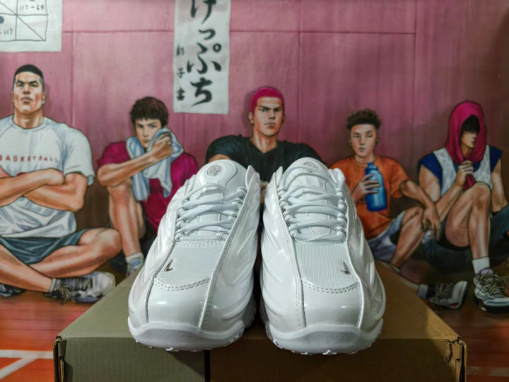 Pair of white sneakers with silver accents viewed from the front