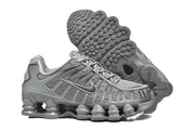 Grey Nike Shox TL sneakers shown from the side and underside, including the patterned outsole.