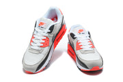 Pair of Nike Air Max 90 sneakers viewed from the front.