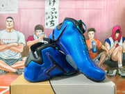 Angled view of blue Nike basketball sneakers with perforated panels and turquoise laces